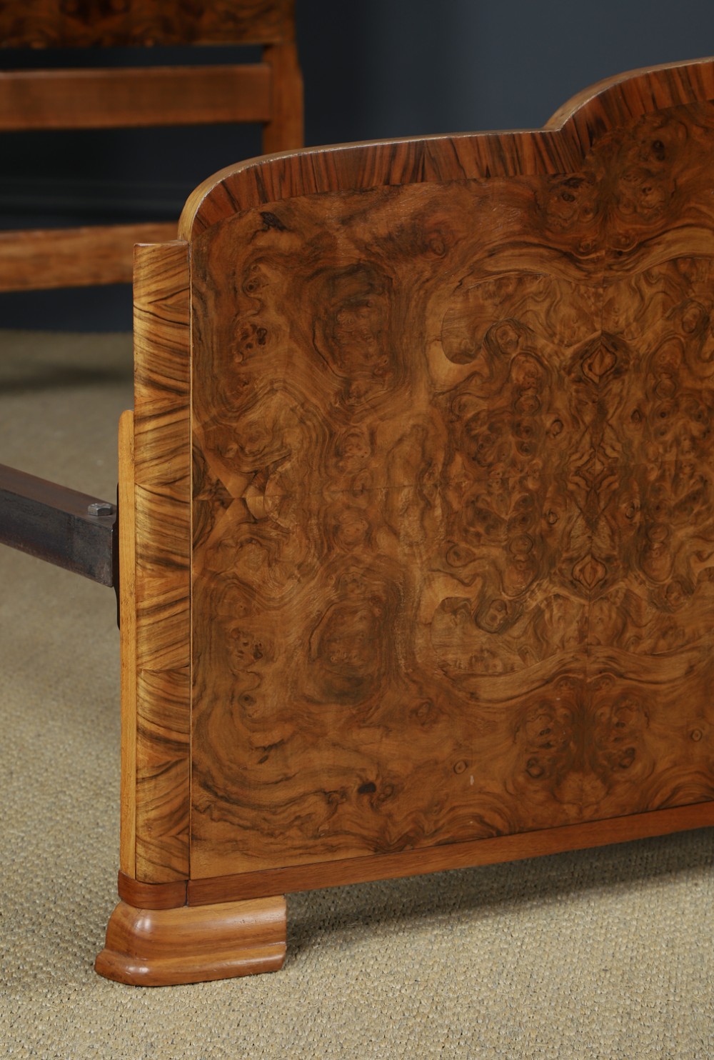An Art Deco double bed frame featuring a curved cloud-shaped headboard and footboard crafted from figured burr walnut veneer. View III