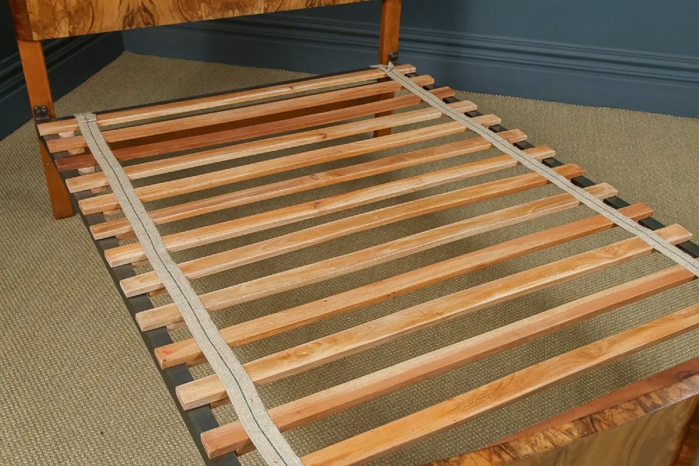 An Art Deco double bed frame featuring a curved cloud-shaped headboard and footboard crafted from figured burr walnut veneer. View XIV
