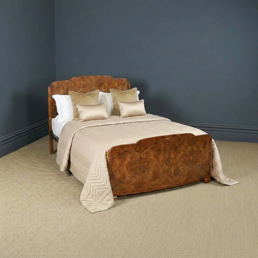 An Art Deco double bed frame featuring a curved cloud-shaped headboard and footboard crafted from figured burr walnut veneer.
