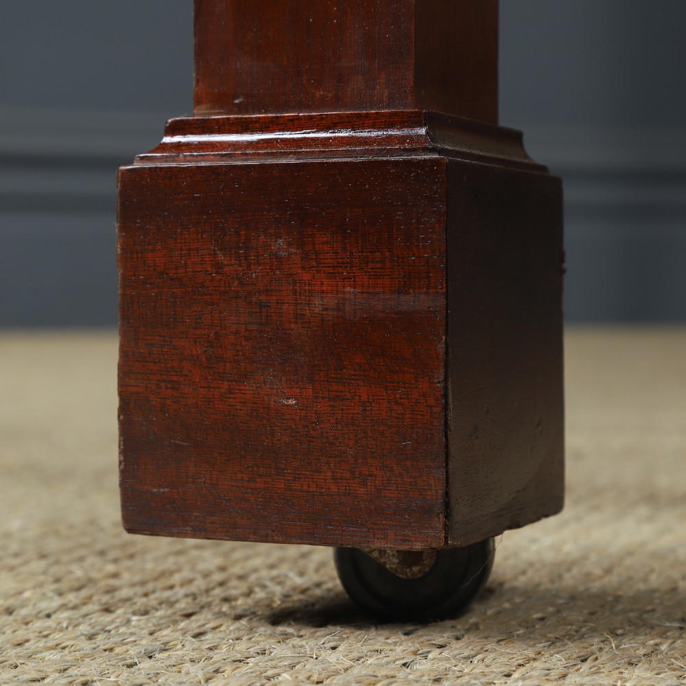An Edwardian mahogany single four poster bed with turned posts, an arched canopy structure, and neutral drapery. View VI