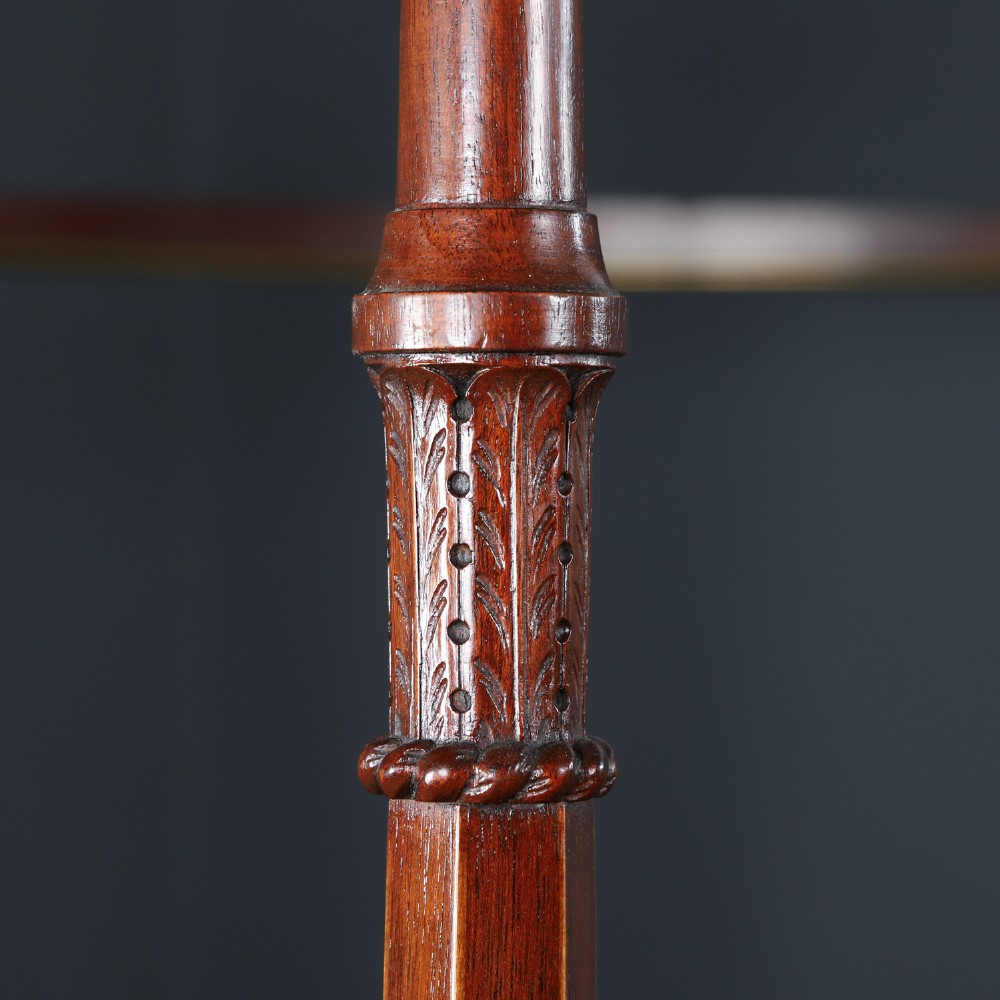An Edwardian mahogany single four poster bed with turned posts, an arched canopy structure, and neutral drapery. View VIII