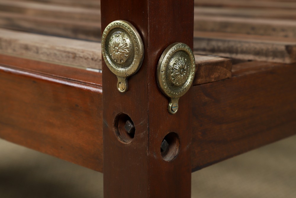 An Edwardian mahogany single four poster bed with turned posts, an arched canopy structure, and neutral drapery. View XIII