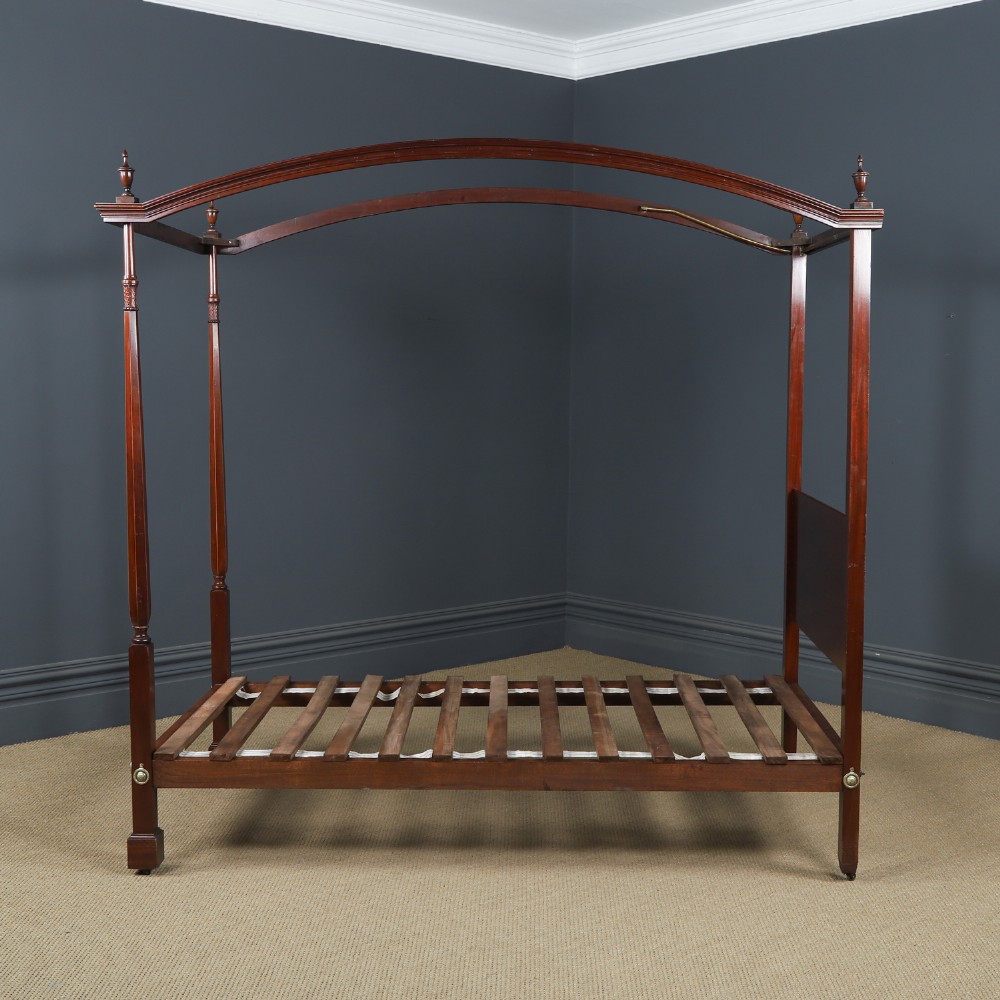 An Edwardian mahogany single four poster bed with turned posts, an arched canopy structure, and neutral drapery. View XIV
