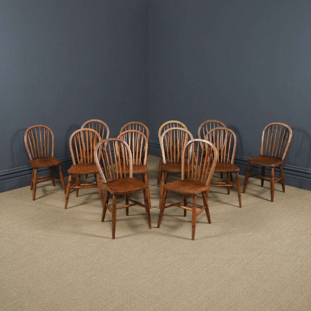 A set of twelve antique English ash and elm Windsor dining chairs with hoop stick backs and turned legs.