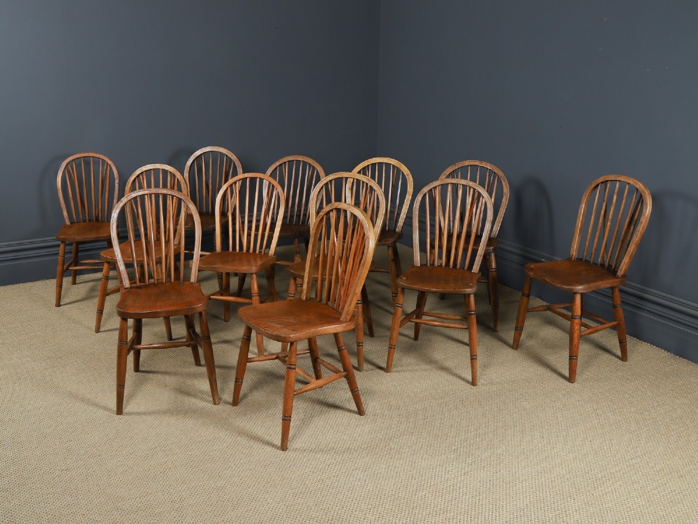 A set of twelve antique English ash and elm Windsor dining chairs with hoop stick backs and turned legs. View II