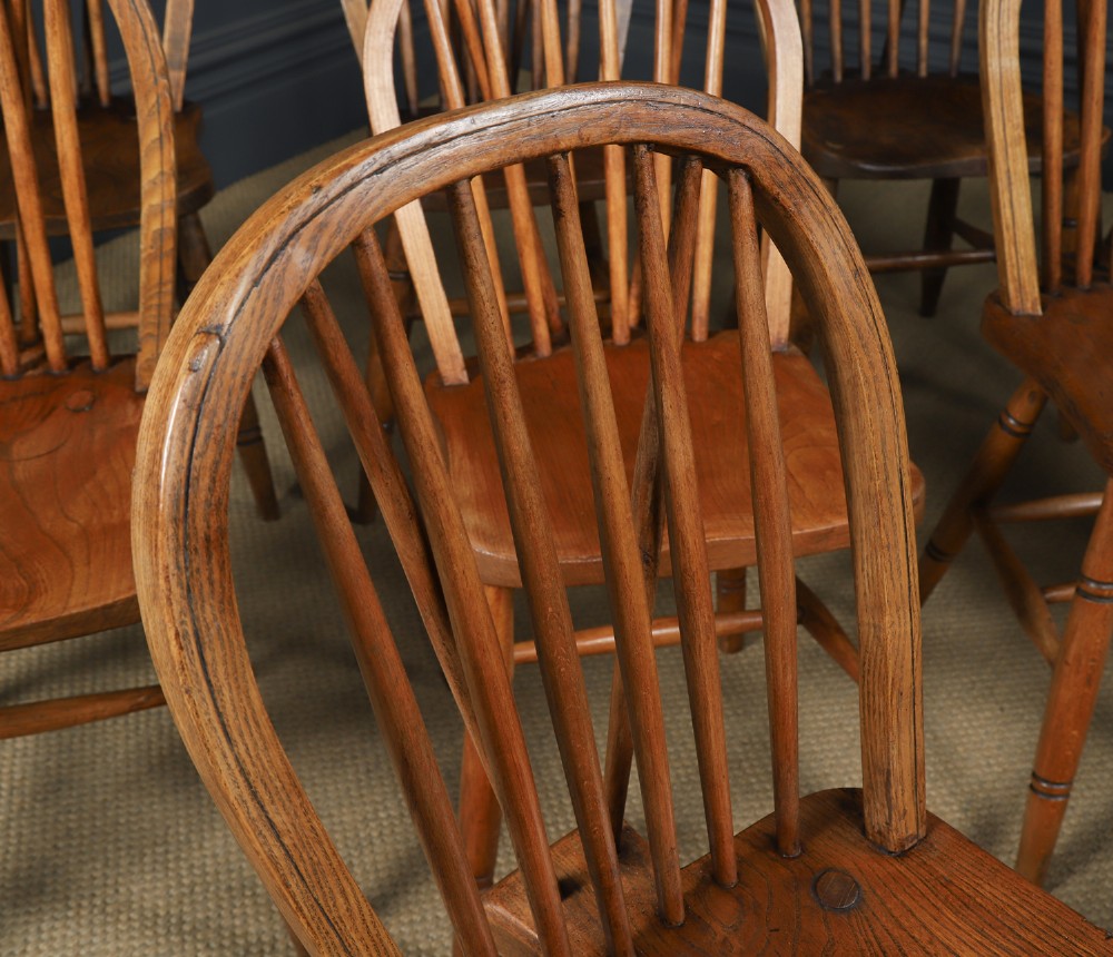 A set of twelve antique English ash and elm Windsor dining chairs with hoop stick backs and turned legs. View VI