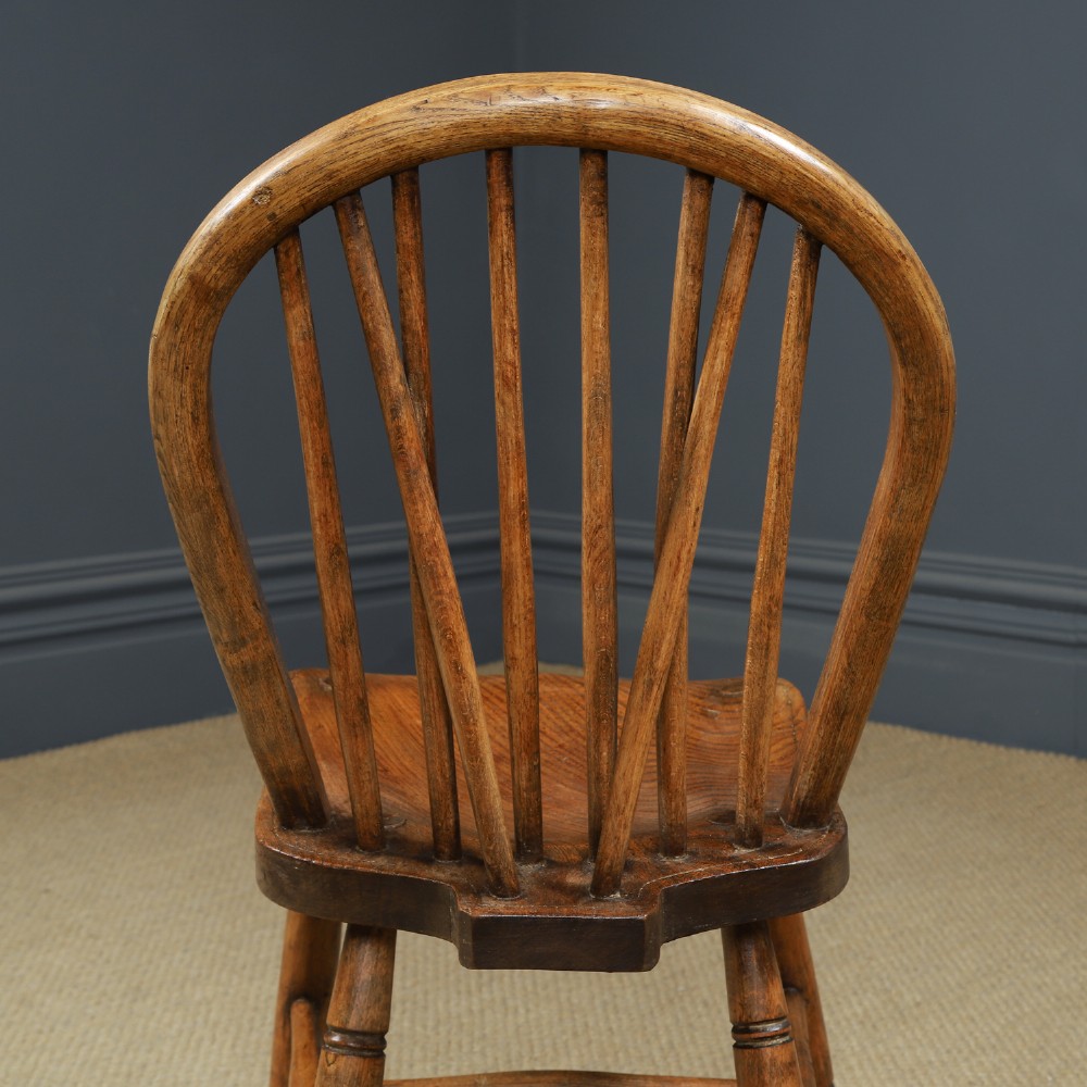 A set of twelve antique English ash and elm Windsor dining chairs with hoop stick backs and turned legs. View XIII