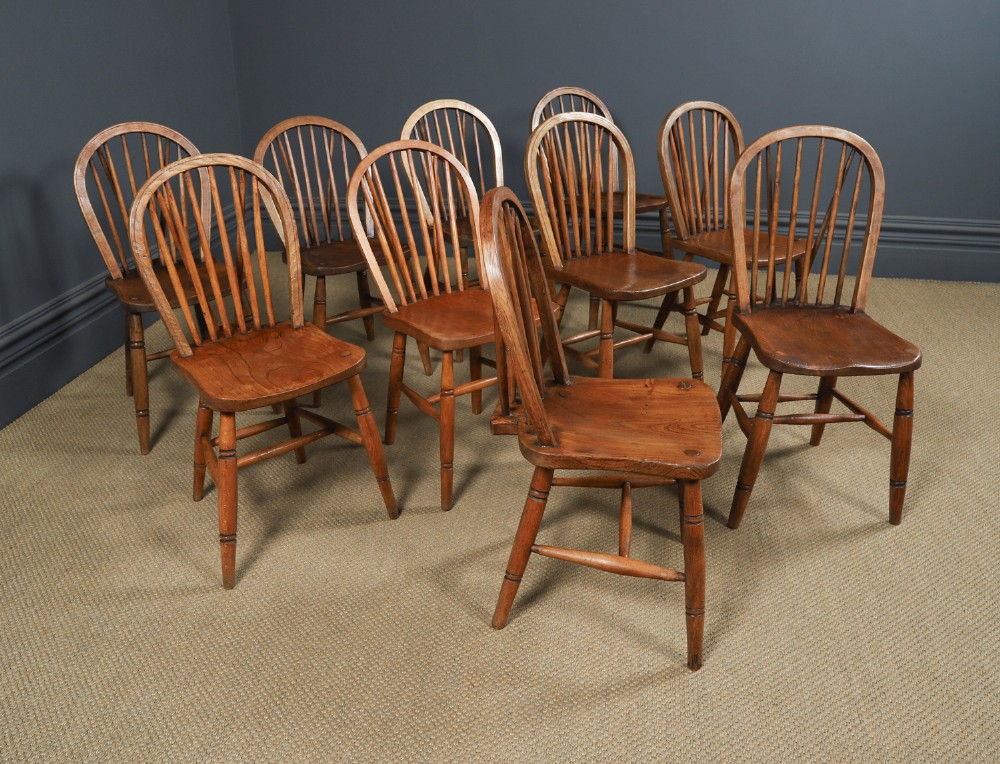 Set of ten warm brown ash and elm Windsor dining chairs with hoop and stick backrests. View II