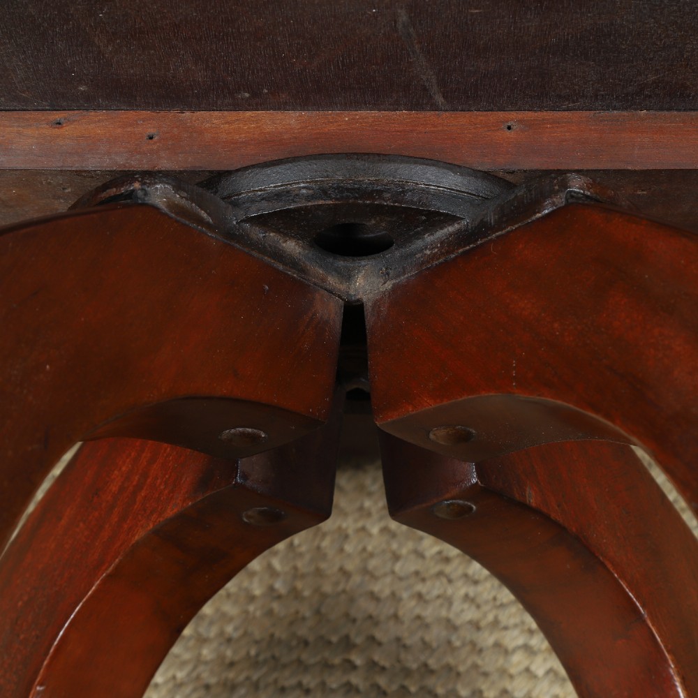 Victorian mahogany revolving desk armchair featuring a curved crest rail, pierced splat back, contoured wooden seat, and four legs with castors. View XV