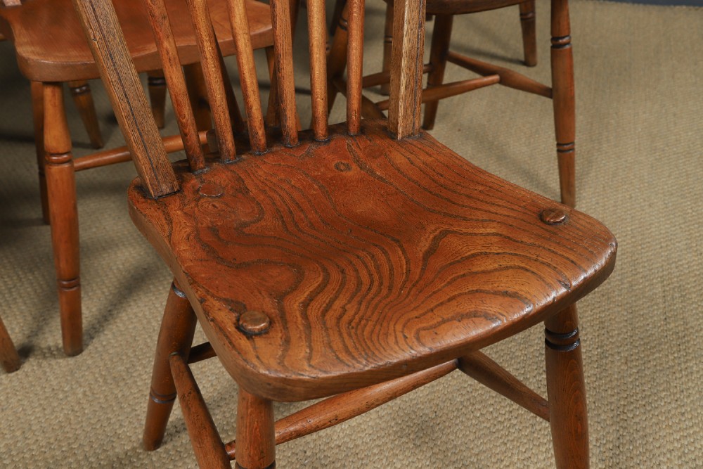 A set of eight antique Edwardian ash and elm Windsor dining chairs with arched hoop stick backs, shaped seats, and turned legs. View III