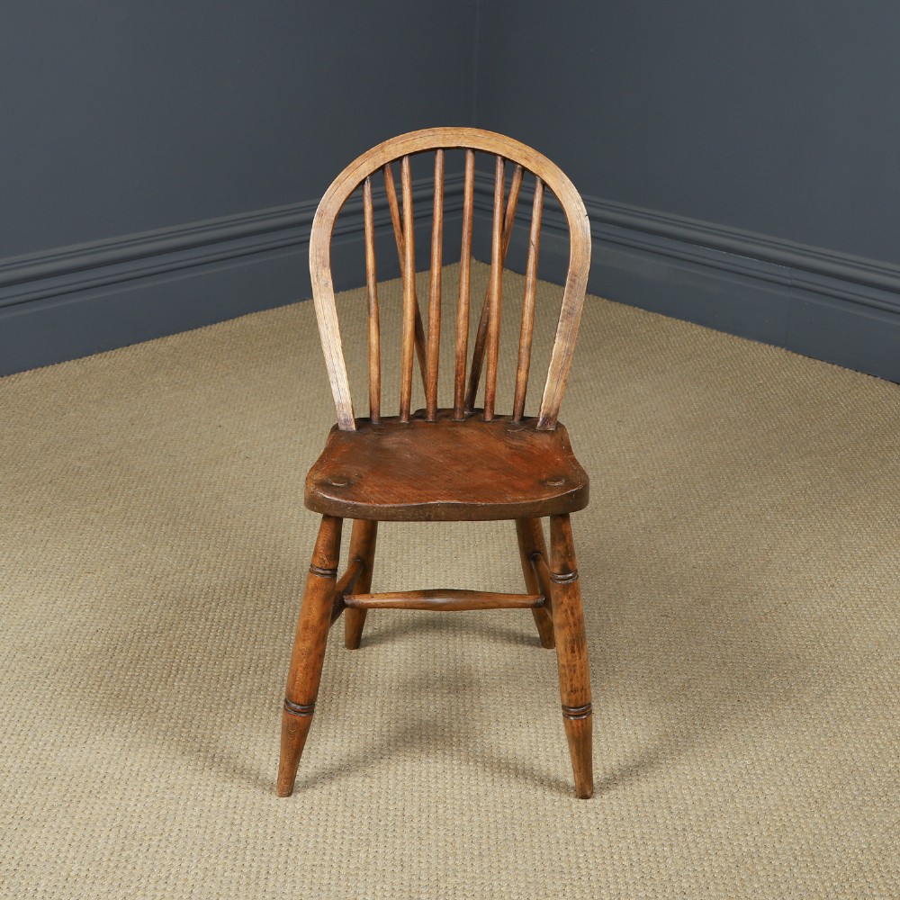 A set of eight antique Edwardian ash and elm Windsor dining chairs with arched hoop stick backs, shaped seats, and turned legs. View IX