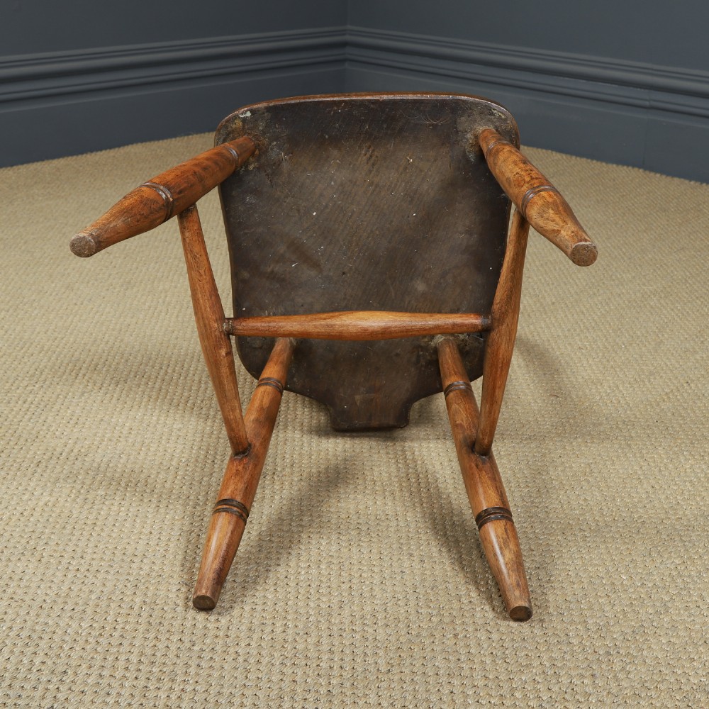 A set of eight antique Edwardian ash and elm Windsor dining chairs with arched hoop stick backs, shaped seats, and turned legs. View XV