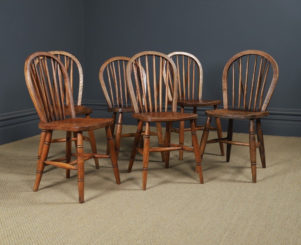 A set of six Edwardian Windsor dining chairs crafted from ash and elm wood, featuring hoop-and-stick backs, shaped seats, turned legs, and H-stretchers. View II
