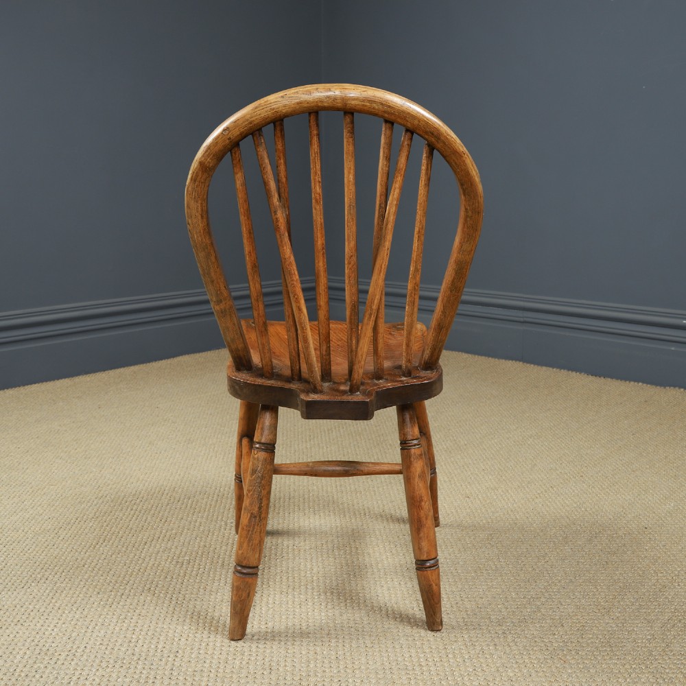 A set of six Edwardian Windsor dining chairs crafted from ash and elm wood, featuring hoop-and-stick backs, shaped seats, turned legs, and H-stretchers. View XII