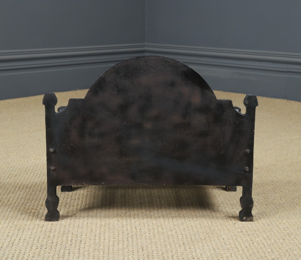 A black cast iron open fire grate featuring an arched backplate decorated with an urn relief and a palisade front basket resting on four square legs. View XIII