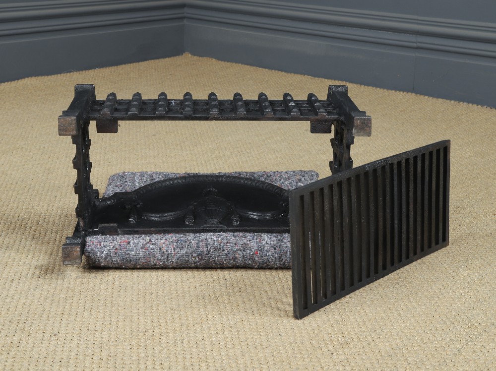 A black cast iron open fire grate featuring an arched backplate decorated with an urn relief and a palisade front basket resting on four square legs. View XIV