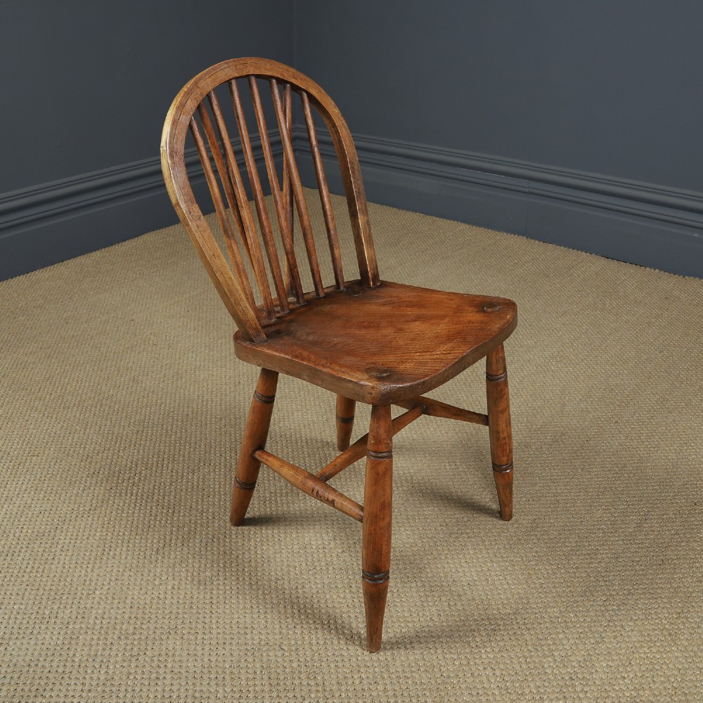 A set of four antique English warm brown ash and elm Windsor dining chairs featuring hoop backs, stick spindles, and turned legs. View VII