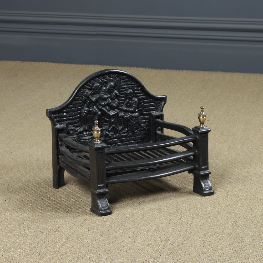 A black cast iron fire grate featuring an arched pictorial backplate, curved front bars, and brass urn finials on the front posts. View IV