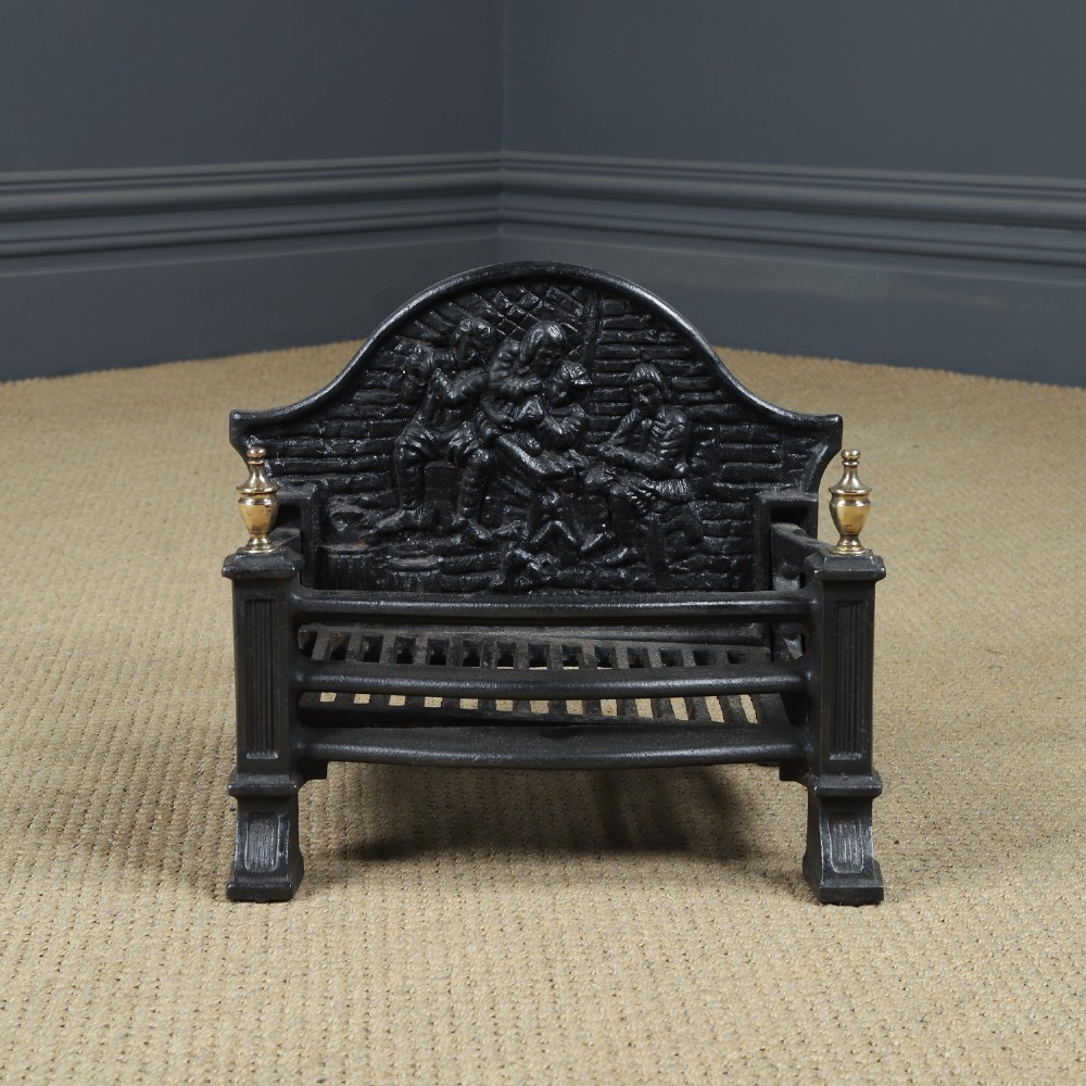 A black cast iron fire grate featuring an arched pictorial backplate, curved front bars, and brass urn finials on the front posts. View V