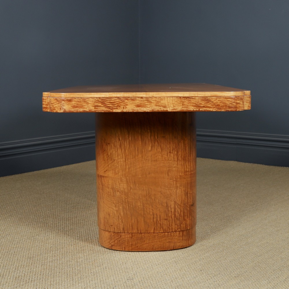An English Art Deco dining suite featuring a rectangular satinwood and maple dining table with a glass top and six cream leather upholstered chairs with curved veneered backs. View XIII