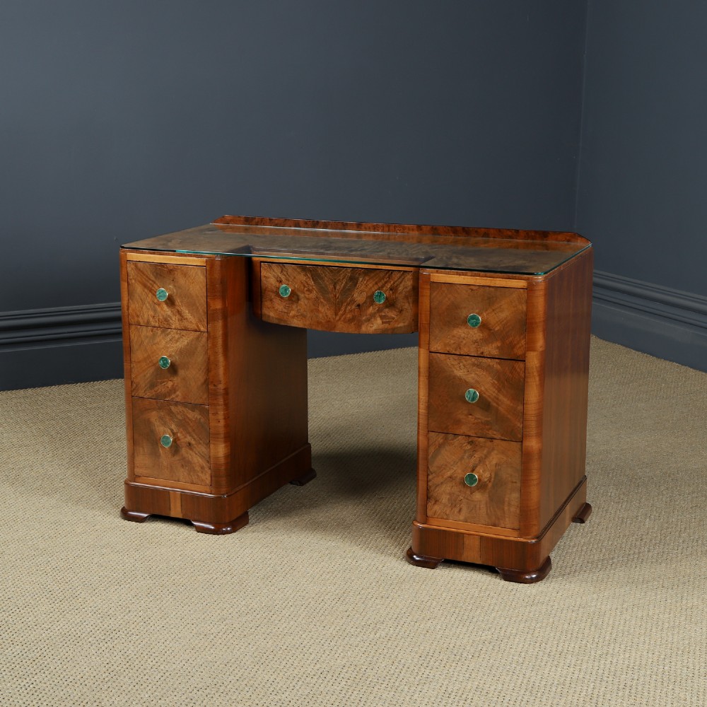 An Art Deco burr walnut pedestal writing desk with green circular knobs and a fitted glass top. View VIII