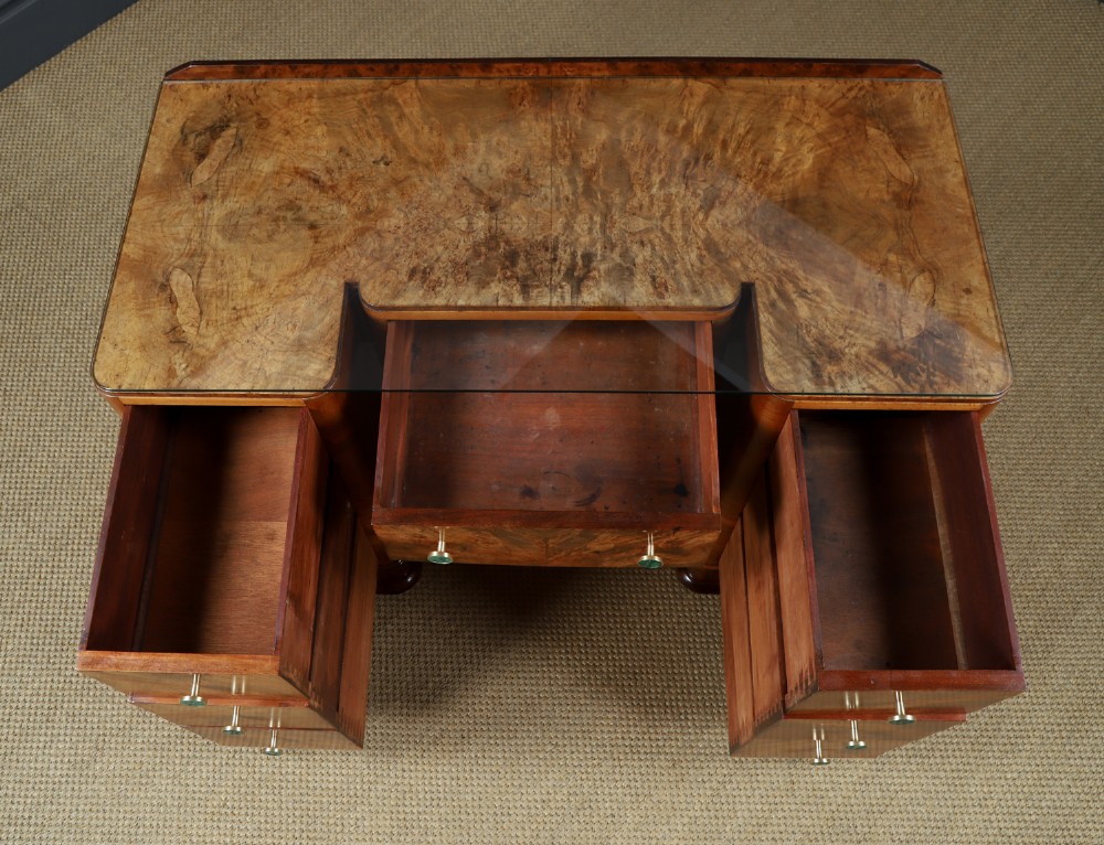 An Art Deco burr walnut pedestal writing desk with green circular knobs and a fitted glass top. View XI