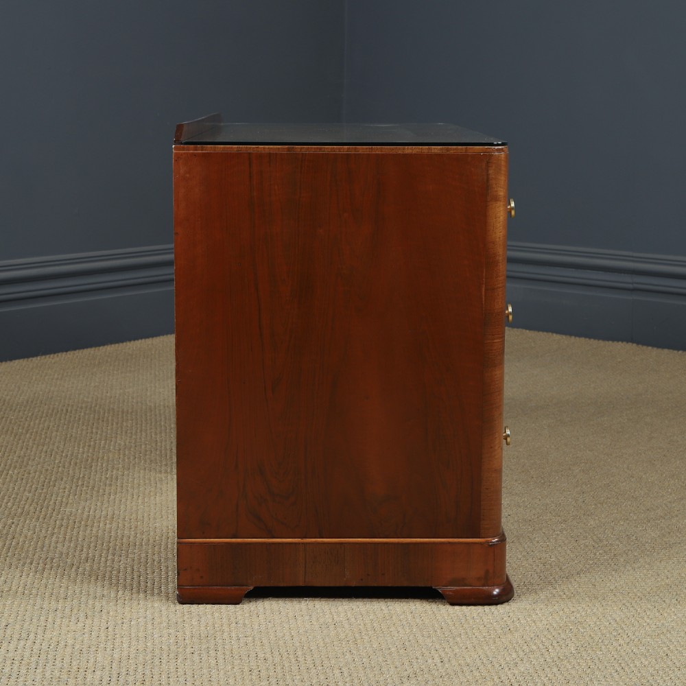 An Art Deco burr walnut pedestal writing desk with green circular knobs and a fitted glass top. View XII