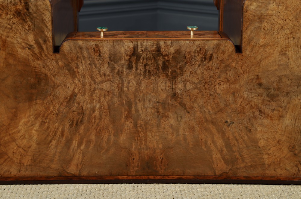 An Art Deco burr walnut pedestal writing desk with green circular knobs and a fitted glass top. View XIII