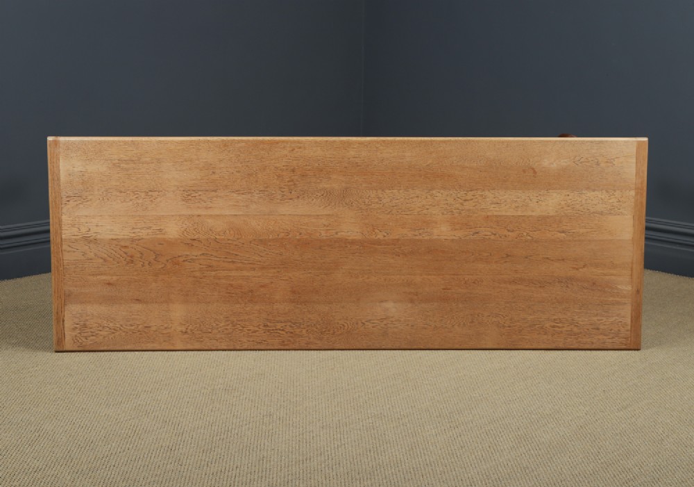 A long Victorian 19th-century refectory dining table with a light pitch pine top and dark oak frame on turned legs. View VII