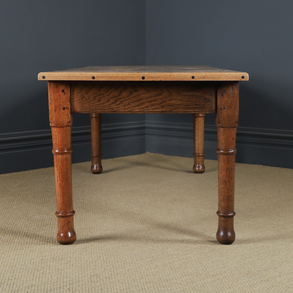 A long Victorian 19th-century refectory dining table with a light pitch pine top and dark oak frame on turned legs. View X