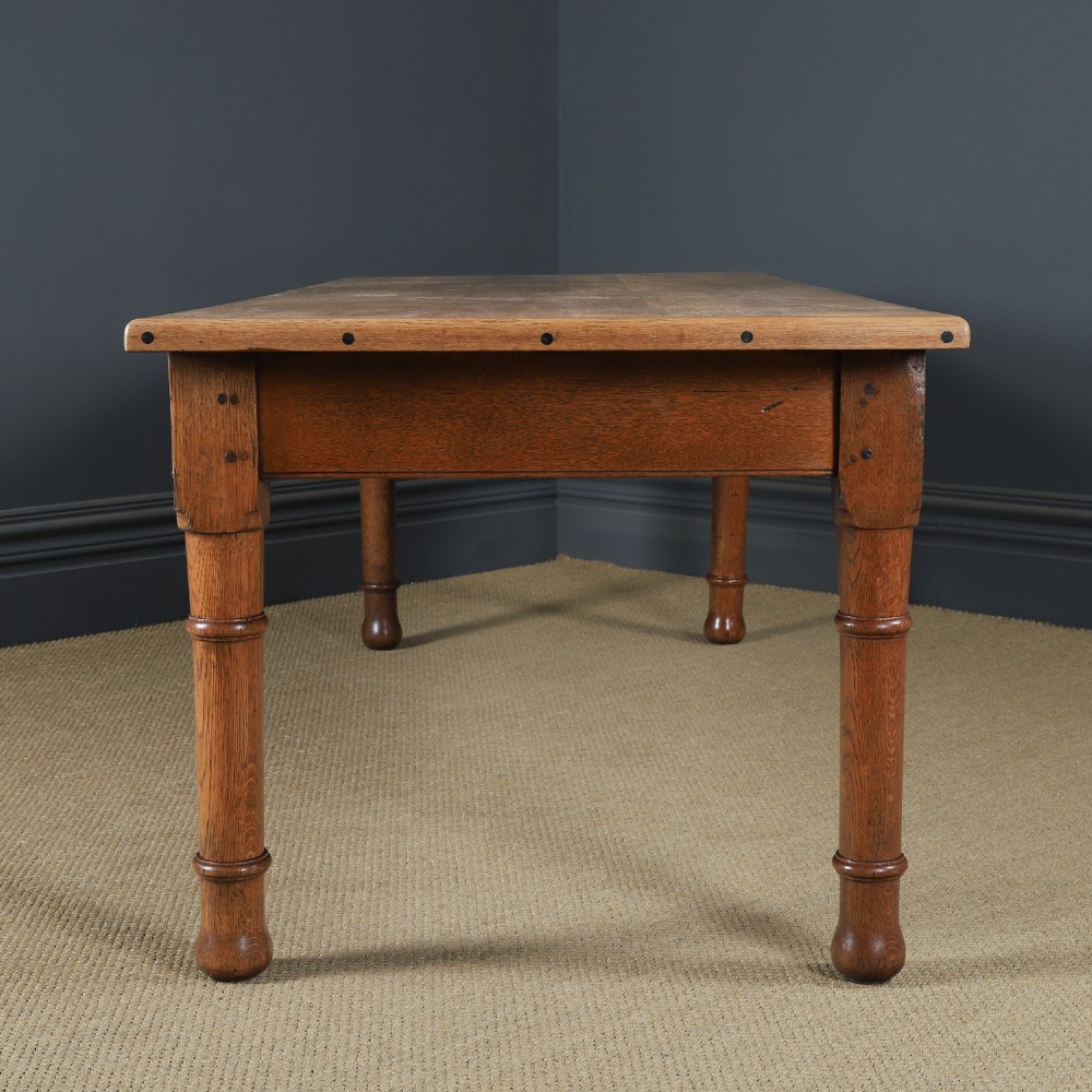 A long Victorian 19th-century refectory dining table with a light pitch pine top and dark oak frame on turned legs. View XI