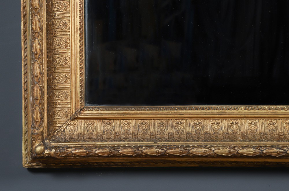 A rectangular Victorian gilt wall mirror featuring a moulded frame with classical leaf and beaded details. View IV