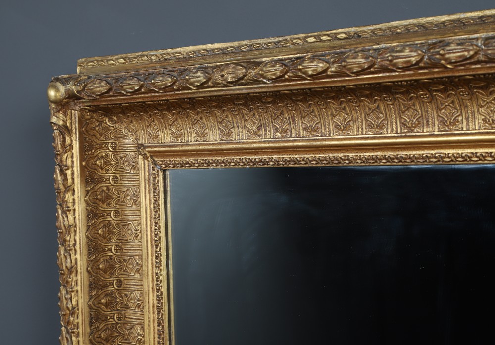 A rectangular Victorian gilt wall mirror featuring a moulded frame with classical leaf and beaded details. View X