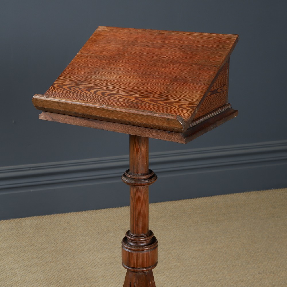 An antique Victorian pitch pine lectern featuring a slanted book rest, turned central column, and a Gothic-style pedestal base. View II