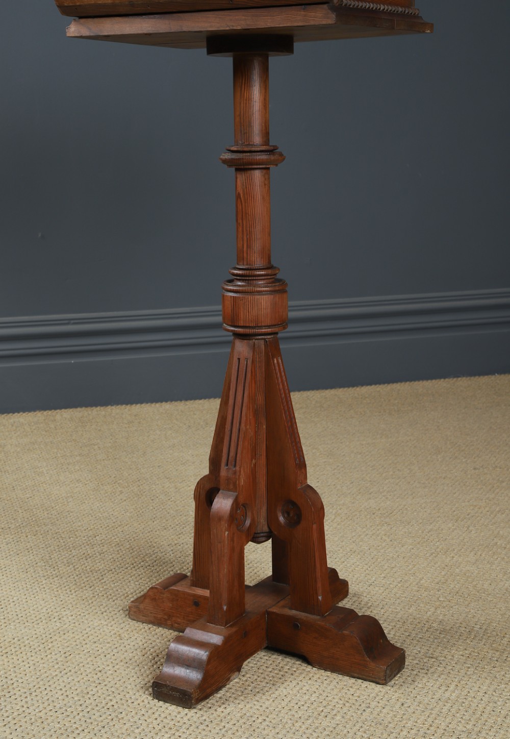 An antique Victorian pitch pine lectern featuring a slanted book rest, turned central column, and a Gothic-style pedestal base. View IV