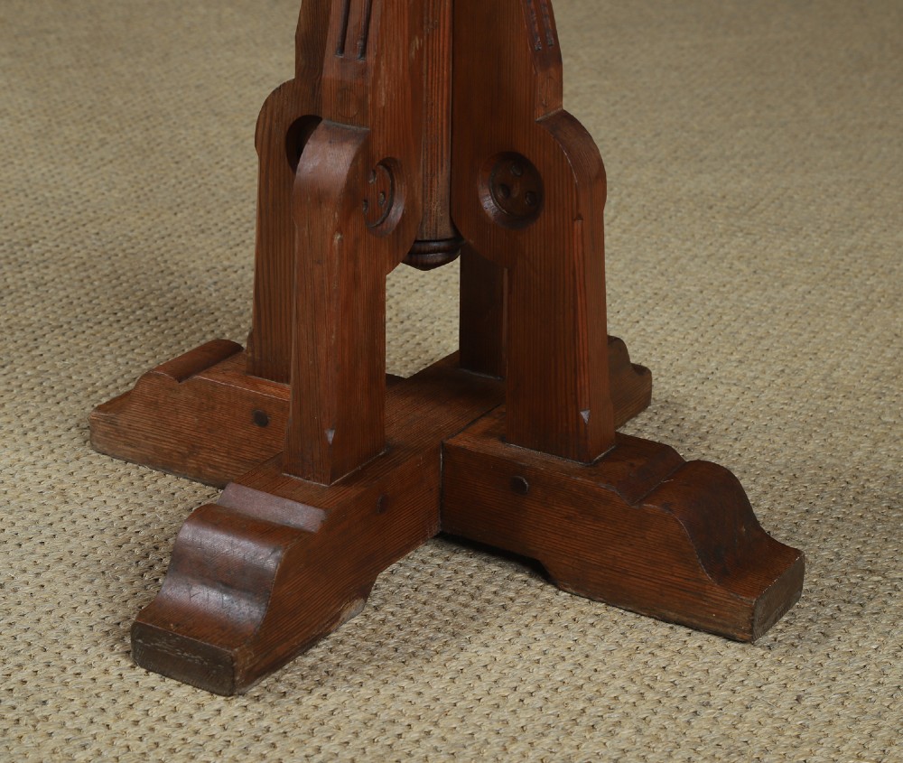 An antique Victorian pitch pine lectern featuring a slanted book rest, turned central column, and a Gothic-style pedestal base. View V