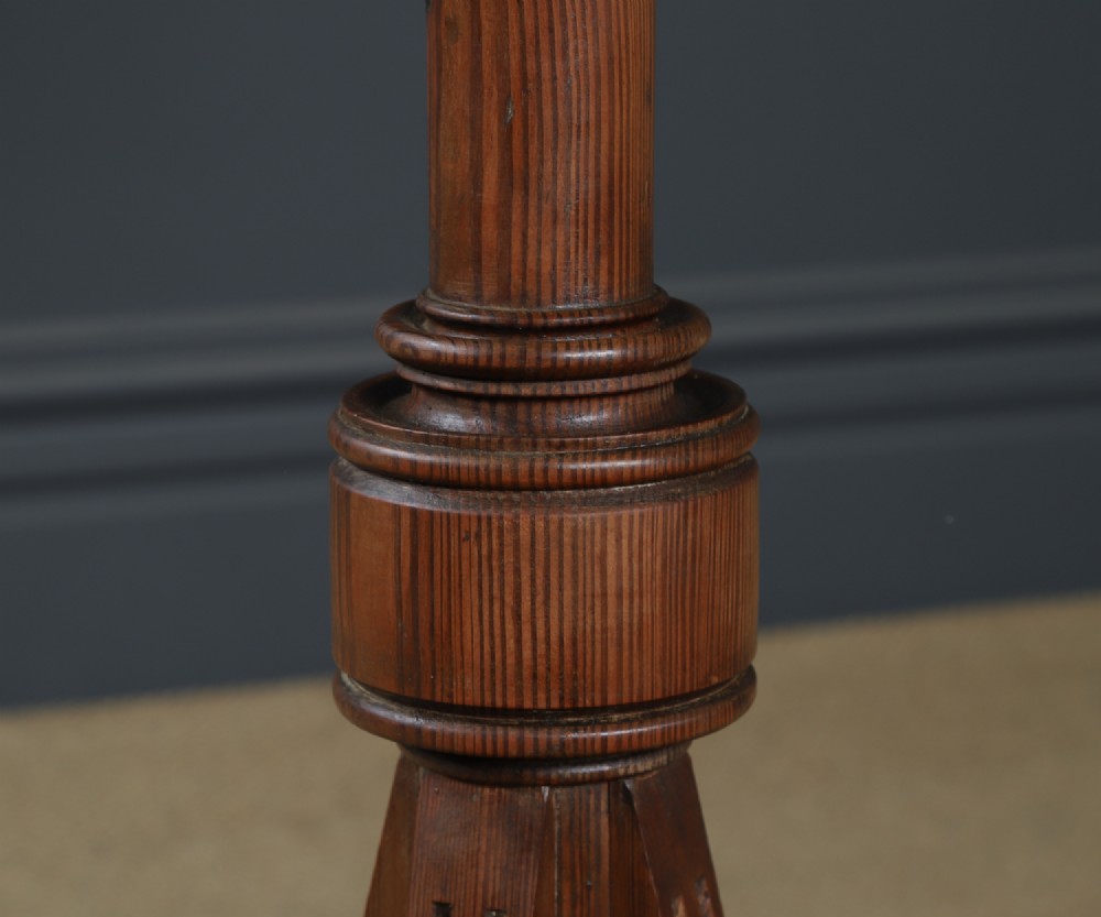 An antique Victorian pitch pine lectern featuring a slanted book rest, turned central column, and a Gothic-style pedestal base. View VII