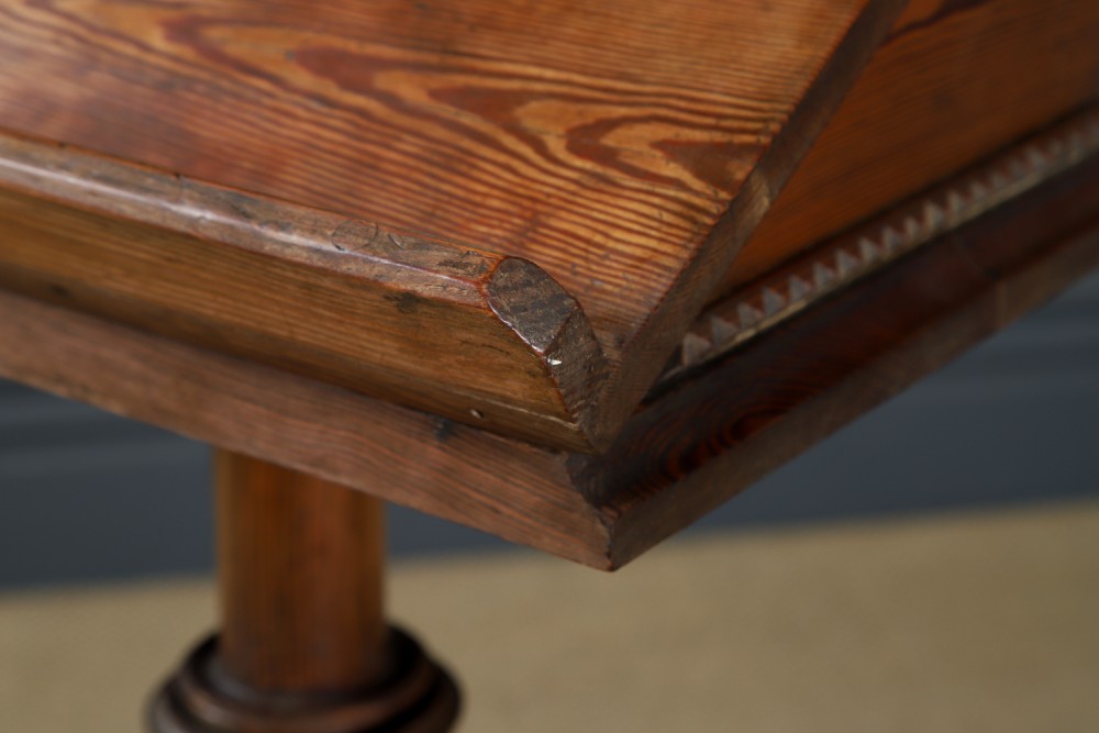 An antique Victorian pitch pine lectern featuring a slanted book rest, turned central column, and a Gothic-style pedestal base. View VIII