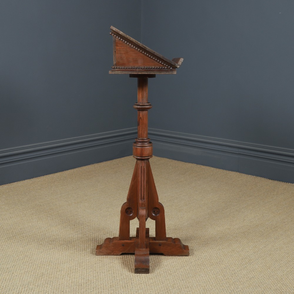 An antique Victorian pitch pine lectern featuring a slanted book rest, turned central column, and a Gothic-style pedestal base. View IX