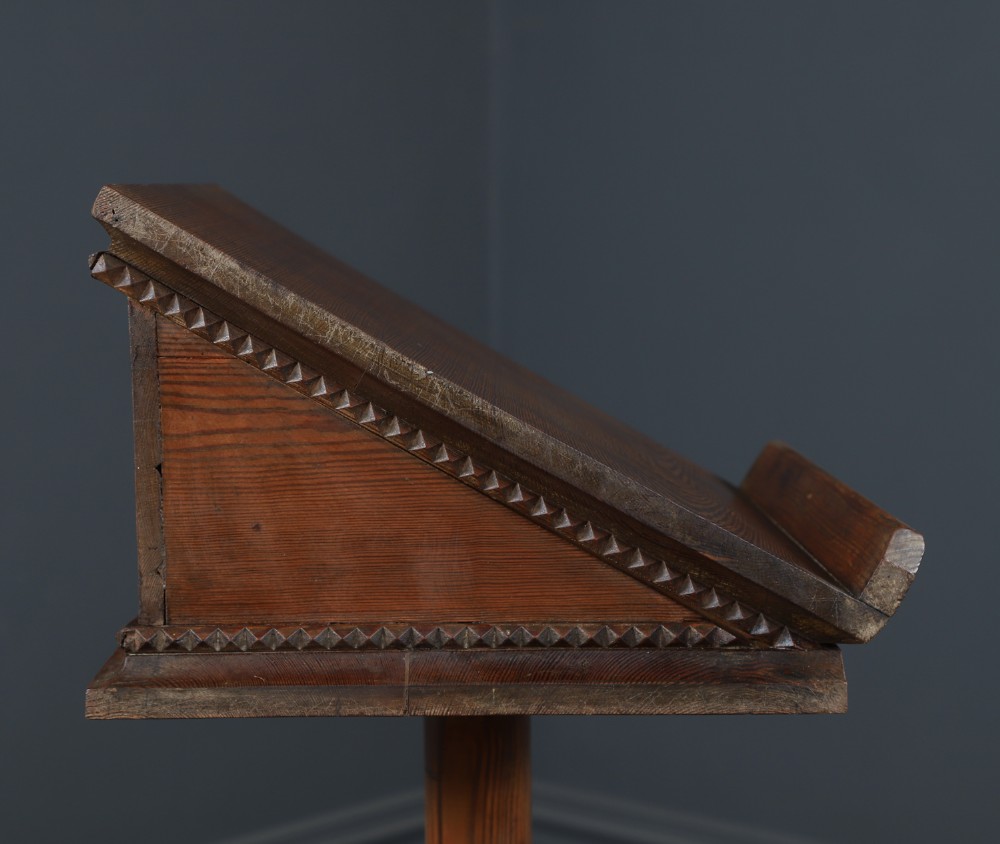 An antique Victorian pitch pine lectern featuring a slanted book rest, turned central column, and a Gothic-style pedestal base. View X