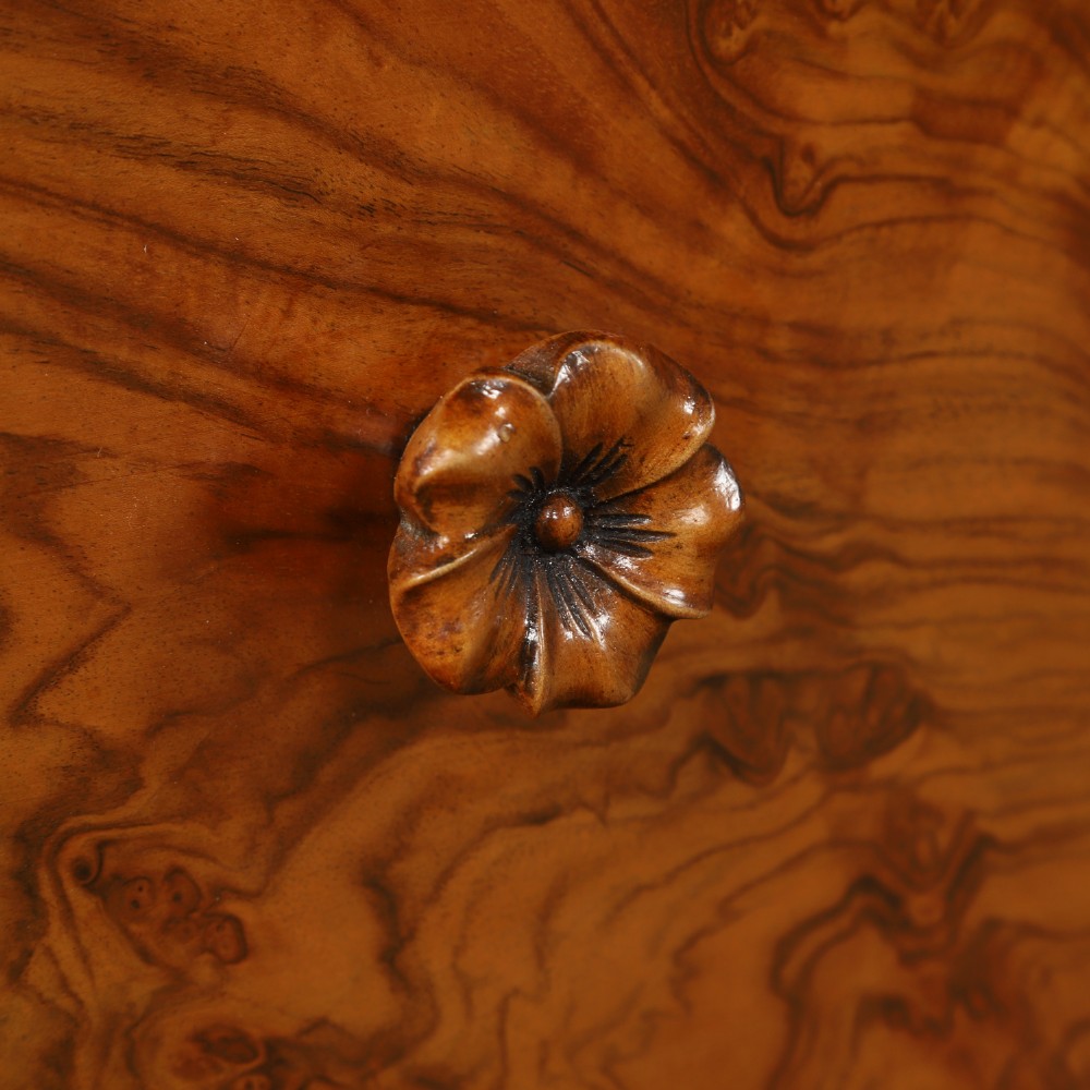 A pair of narrow Art Deco burr walnut bedside cabinets featuring two drawers with carved circular handles and a low back ledge. View IV