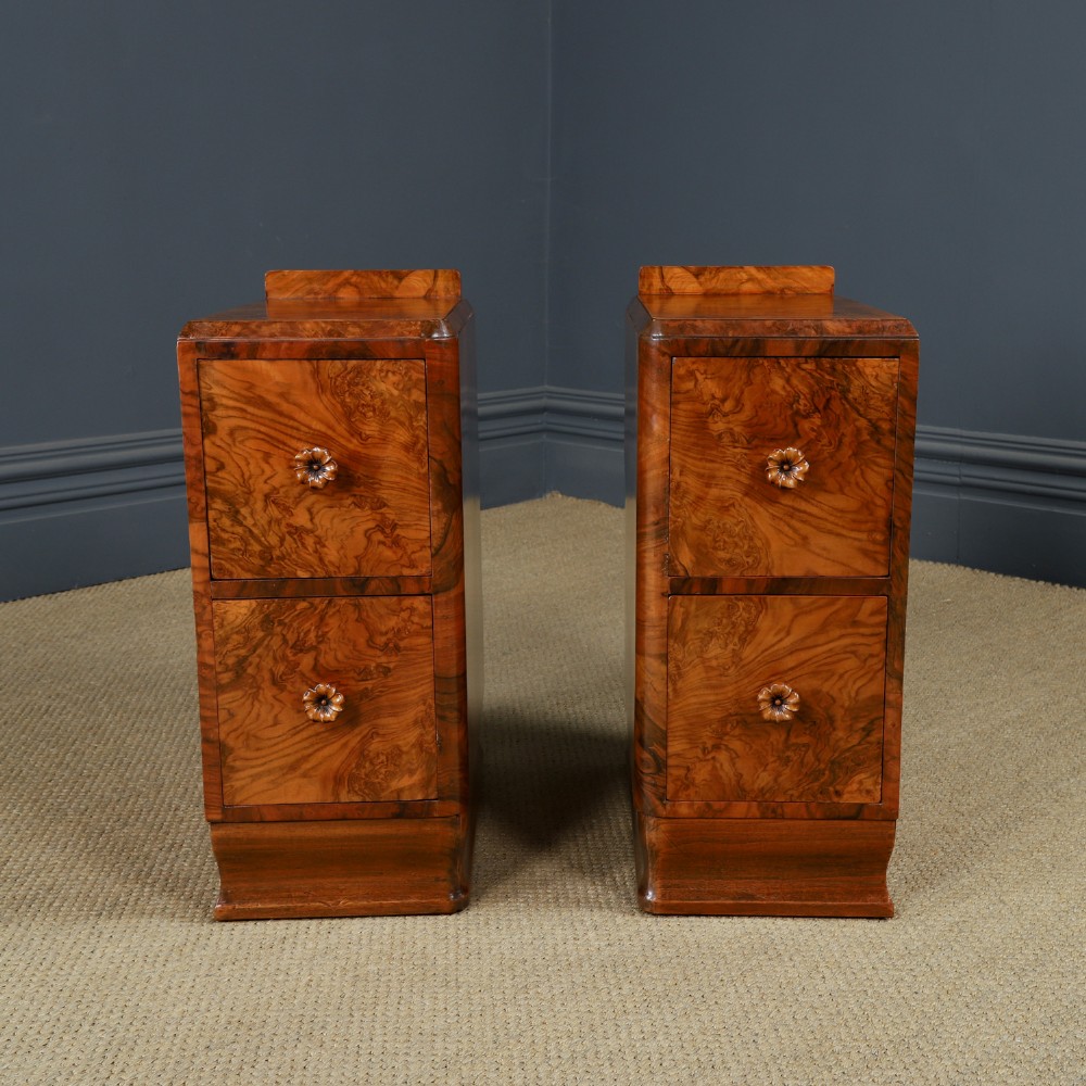 A pair of narrow Art Deco burr walnut bedside cabinets featuring two drawers with carved circular handles and a low back ledge. View VII