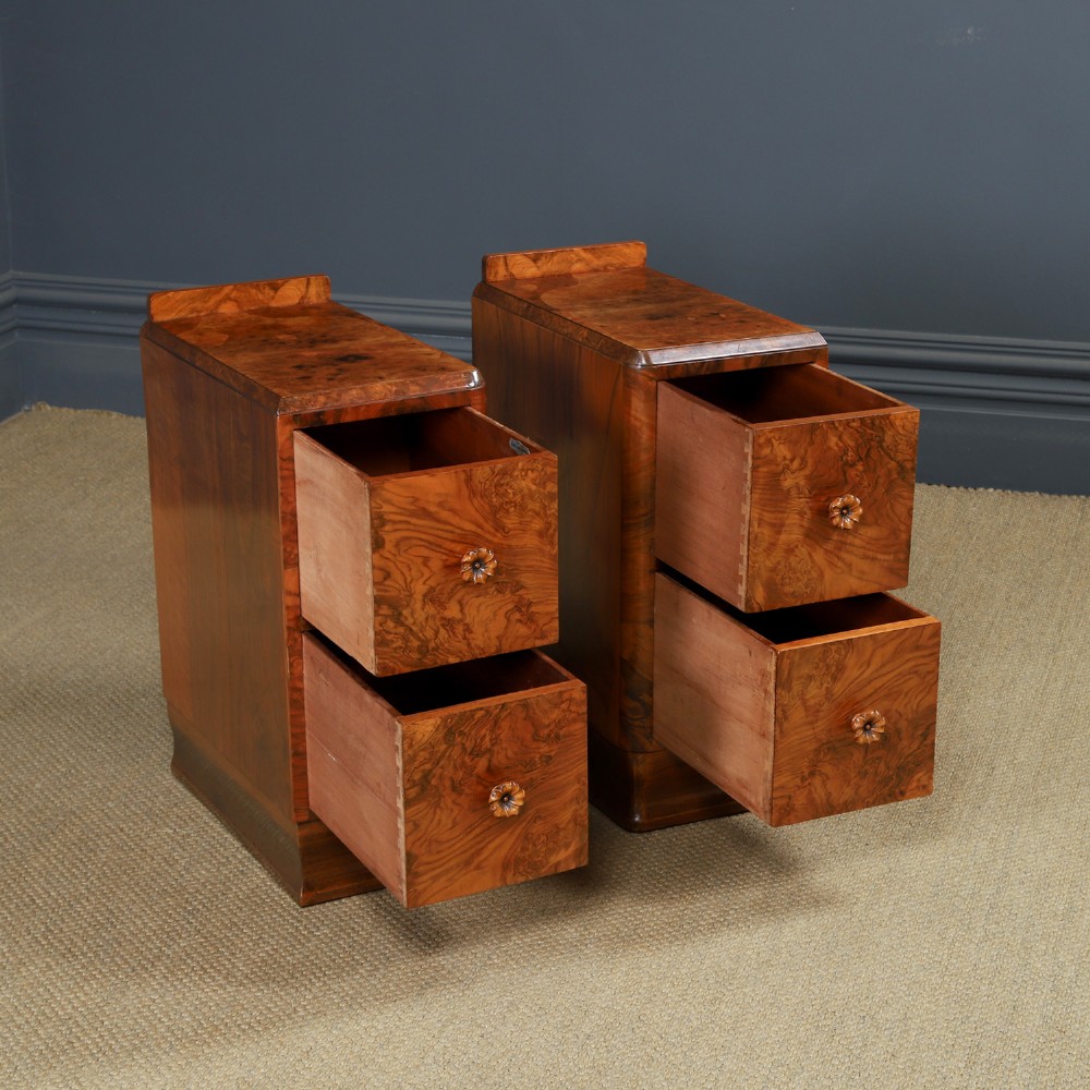 A pair of narrow Art Deco burr walnut bedside cabinets featuring two drawers with carved circular handles and a low back ledge. View IX