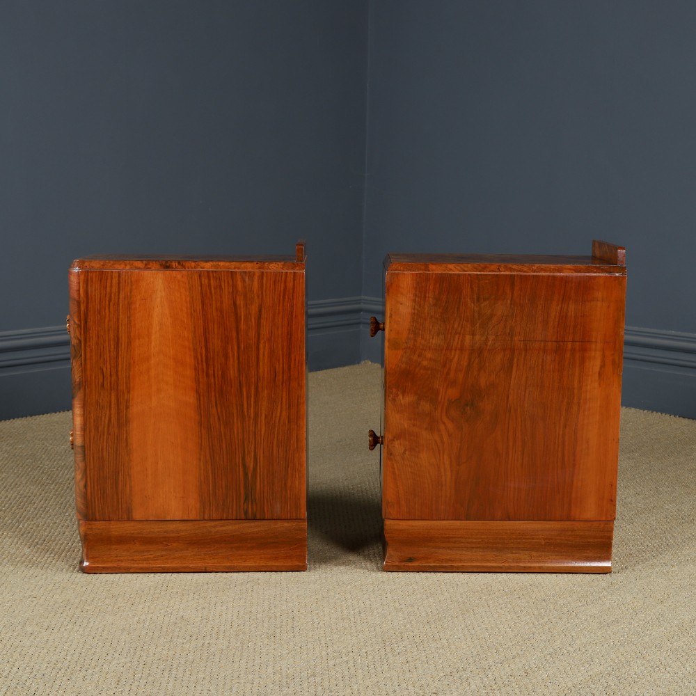 A pair of narrow Art Deco burr walnut bedside cabinets featuring two drawers with carved circular handles and a low back ledge. View XIII