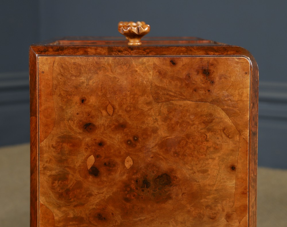 A pair of narrow Art Deco burr walnut bedside cabinets featuring two drawers with carved circular handles and a low back ledge. View XIV