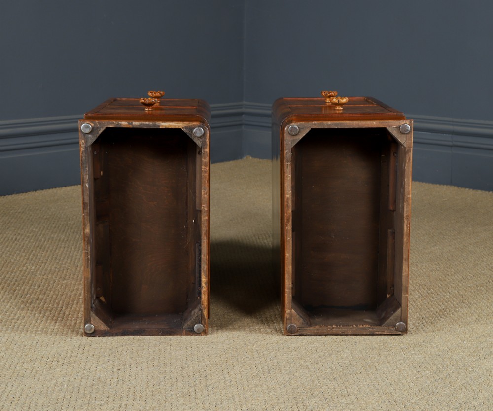 A pair of narrow Art Deco burr walnut bedside cabinets featuring two drawers with carved circular handles and a low back ledge. View XV