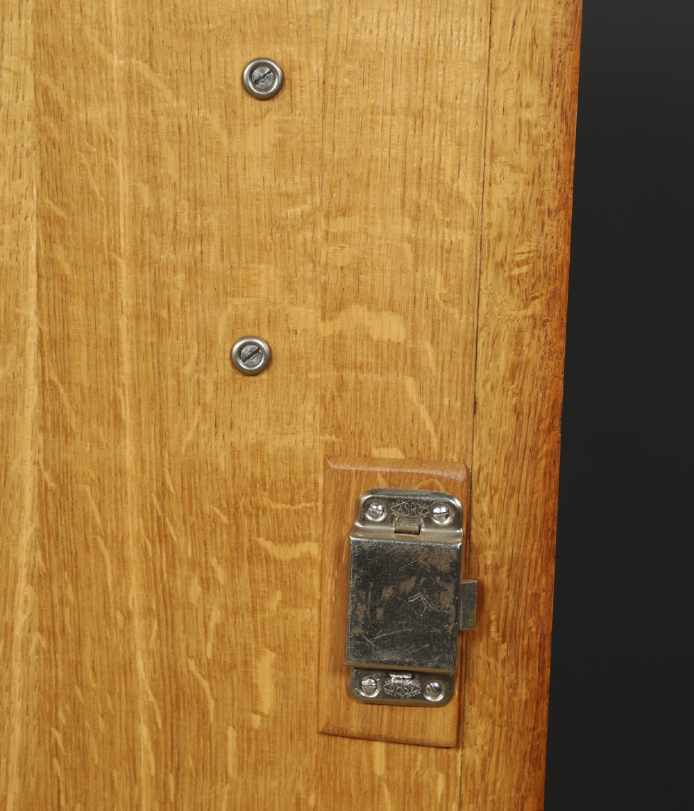 An Art Deco walnut two door wardrobe featuring a bow front design, carved wood handles, and figured timber grain. View XII