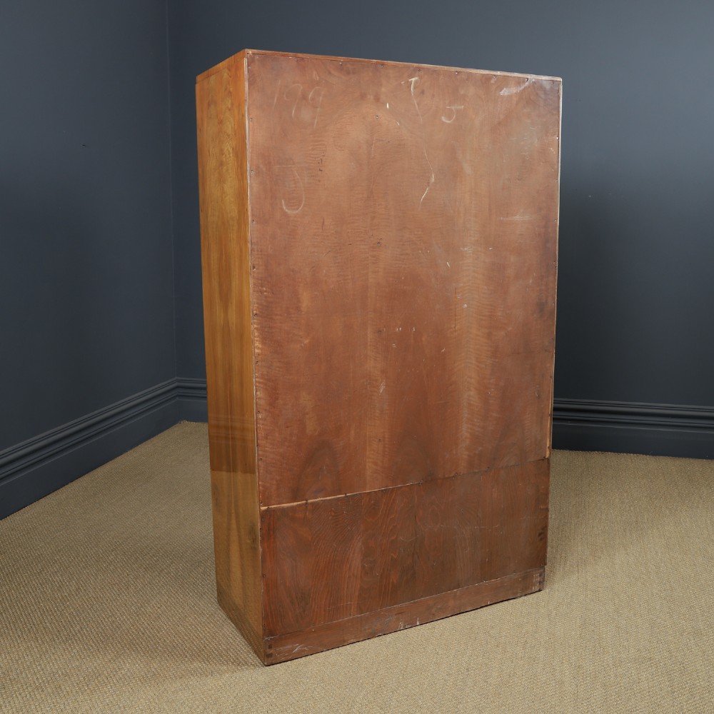 An Art Deco walnut two door wardrobe featuring a bow front design, carved wood handles, and figured timber grain. View XIV