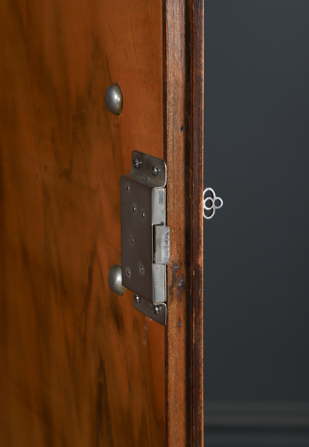 An Art Deco two door wardrobe crafted from warm brown figured walnut veneer with a gently curved bow front and wooden vertical handles. View IX