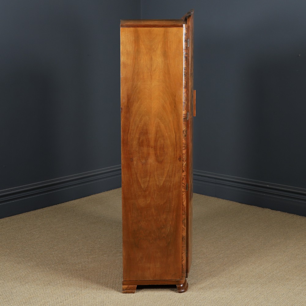 An Art Deco two door wardrobe crafted from warm brown figured walnut veneer with a gently curved bow front and wooden vertical handles. View XIII